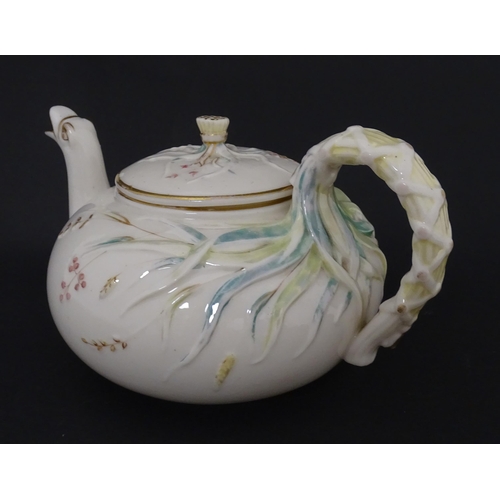 51 - Belleek tea wares in the Grass pattern to include teapots, milk jug, cream jug, teapot stand, saucer... 