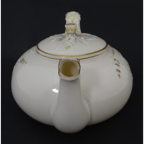 51 - Belleek tea wares in the Grass pattern to include teapots, milk jug, cream jug, teapot stand, saucer... 