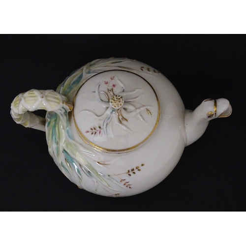 51 - Belleek tea wares in the Grass pattern to include teapots, milk jug, cream jug, teapot stand, saucer... 