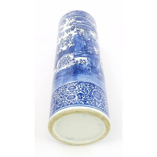 30 - A Chinese blue and white umbrella / stick stand decorated with figures and bamboo. Approx. 24 1/4