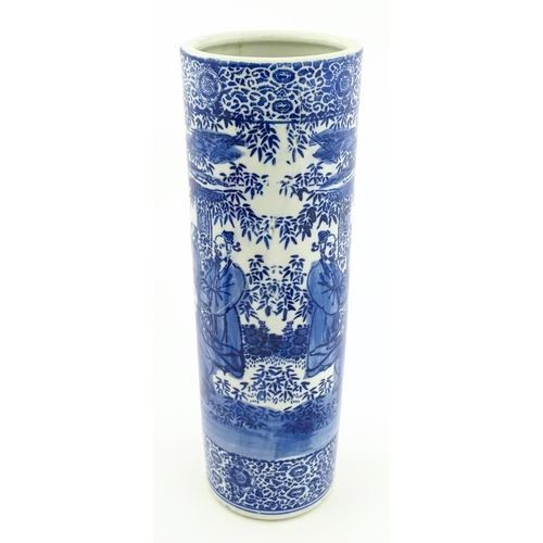 30 - A Chinese blue and white umbrella / stick stand decorated with figures and bamboo. Approx. 24 1/4