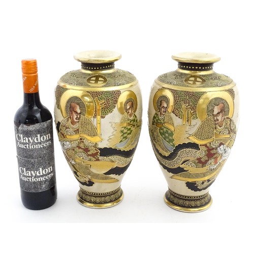 56 - A pair of Japanese satsuma vases decorated with Immortal figures. Character marks under. Approx. 12 ... 