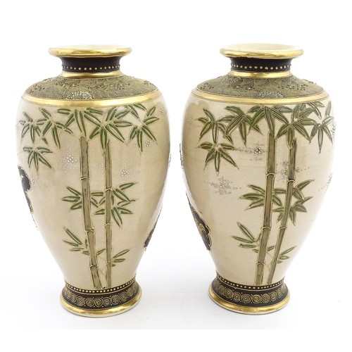 56 - A pair of Japanese satsuma vases decorated with Immortal figures. Character marks under. Approx. 12 ... 