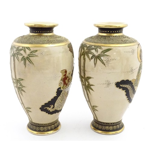 56 - A pair of Japanese satsuma vases decorated with Immortal figures. Character marks under. Approx. 12 ... 