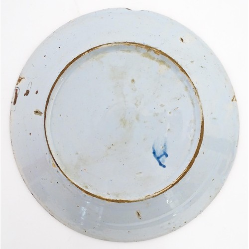 68 - A Delft blue and white plate decorated in the Chinese style with taihu rock, birds, flowers and foli... 