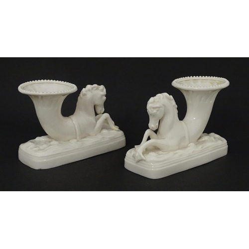 89 - A matched pair of Belleek Seahorse flower holders / vases. One with impressed First Period mark, the... 