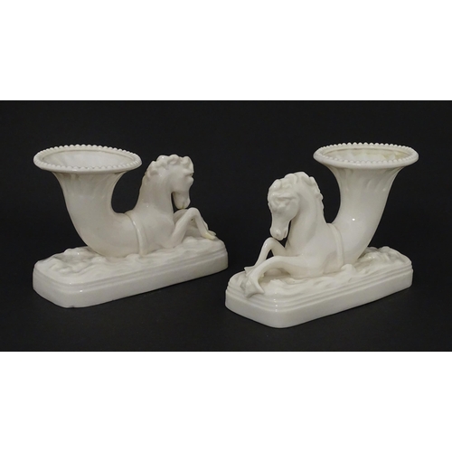 89 - A matched pair of Belleek Seahorse flower holders / vases. One with impressed First Period mark, the... 