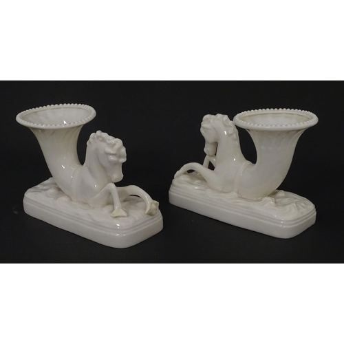 89 - A matched pair of Belleek Seahorse flower holders / vases. One with impressed First Period mark, the... 