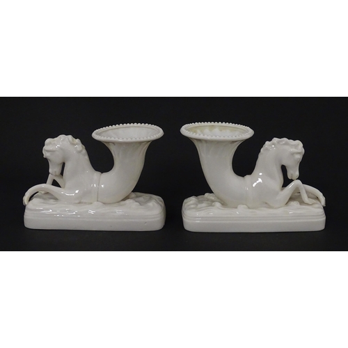 89 - A matched pair of Belleek Seahorse flower holders / vases. One with impressed First Period mark, the... 