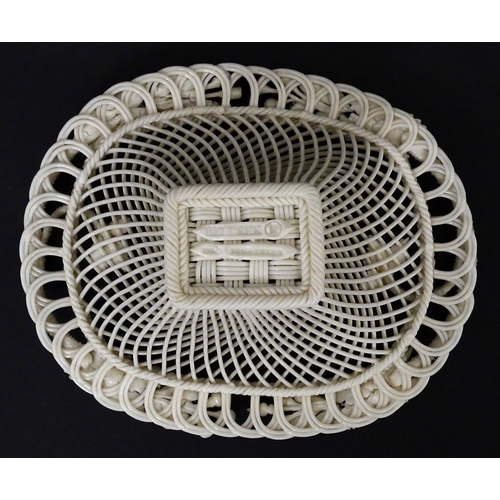 97 - A Belleek four strand Henshall Basket having lattice work with ribbon edges, decorated with flowers ... 