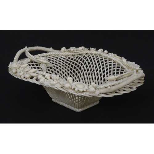 97 - A Belleek four strand Henshall Basket having lattice work with ribbon edges, decorated with flowers ... 