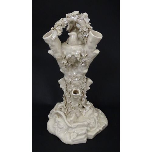 98 - A Belleek Bird Nest Stump vase with floral, foliate and bird decoration. Marked under with Second Pe... 