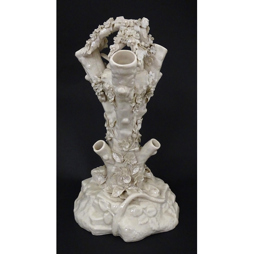 98 - A Belleek Bird Nest Stump vase with floral, foliate and bird decoration. Marked under with Second Pe... 