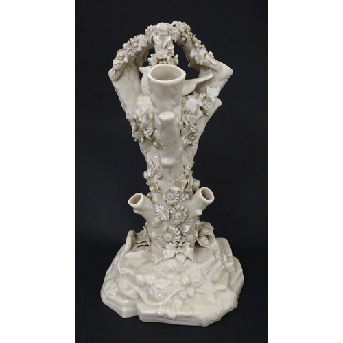 98 - A Belleek Bird Nest Stump vase with floral, foliate and bird decoration. Marked under with Second Pe... 