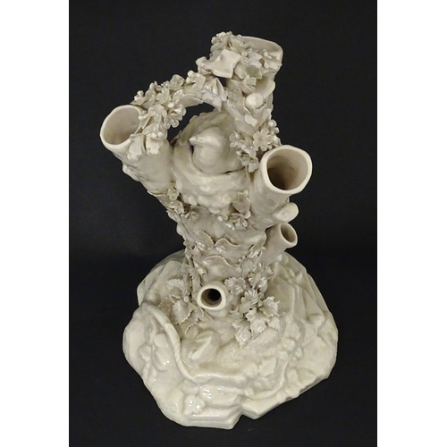 98 - A Belleek Bird Nest Stump vase with floral, foliate and bird decoration. Marked under with Second Pe... 