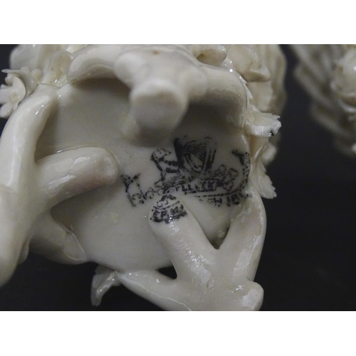 99 - Three Belleek Flowered Spill vases of basket form with floral and foliate decoration and raised on t... 