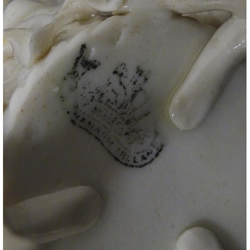 99 - Three Belleek Flowered Spill vases of basket form with floral and foliate decoration and raised on t... 