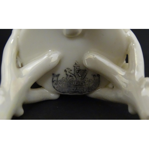 99 - Three Belleek Flowered Spill vases of basket form with floral and foliate decoration and raised on t... 