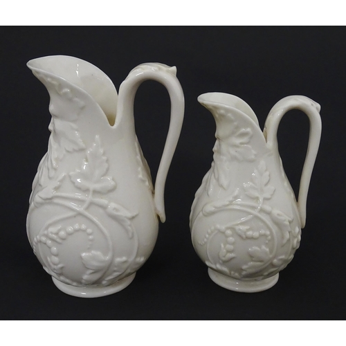 100 - Two Belleek jugs in the Bearded Mask pattern. Both marked with First Period mark under. Largest appr... 