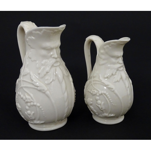 100 - Two Belleek jugs in the Bearded Mask pattern. Both marked with First Period mark under. Largest appr... 