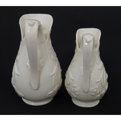 100 - Two Belleek jugs in the Bearded Mask pattern. Both marked with First Period mark under. Largest appr... 