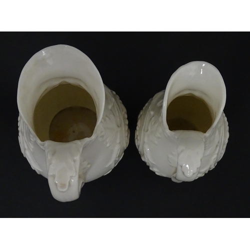 100 - Two Belleek jugs in the Bearded Mask pattern. Both marked with First Period mark under. Largest appr... 