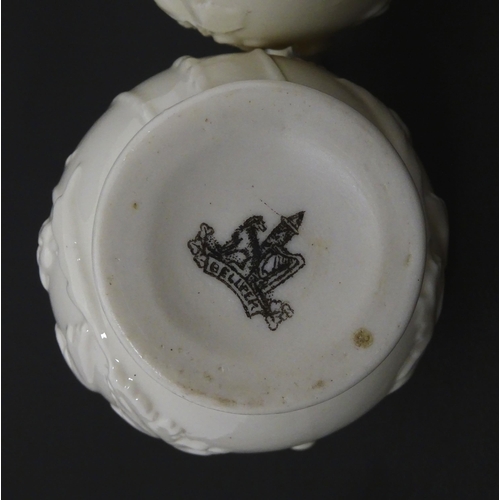 100 - Two Belleek jugs in the Bearded Mask pattern. Both marked with First Period mark under. Largest appr... 