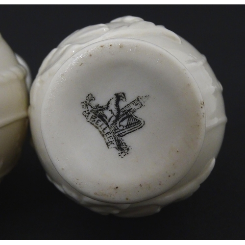 100 - Two Belleek jugs in the Bearded Mask pattern. Both marked with First Period mark under. Largest appr... 