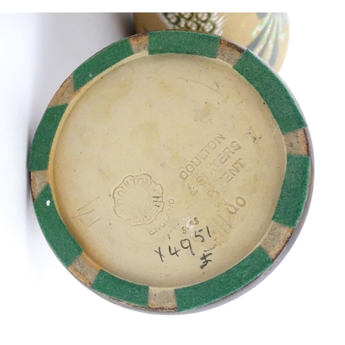 105 - A pair of Doulton Lambeth ewers / pitchers with stylised floral and foliate decoration by Lizzie Mar... 