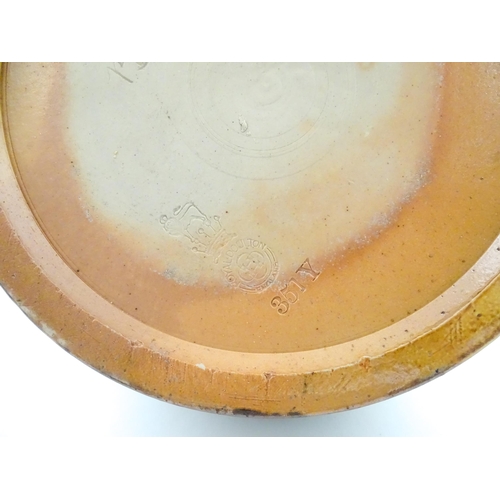 106 - A Royal Doulton stoneware water filter and jug with lid, the mottled green glaze with scrolling and ... 