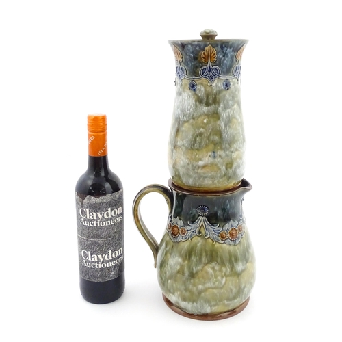 106 - A Royal Doulton stoneware water filter and jug with lid, the mottled green glaze with scrolling and ... 