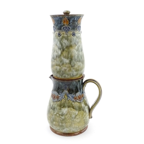 106 - A Royal Doulton stoneware water filter and jug with lid, the mottled green glaze with scrolling and ... 