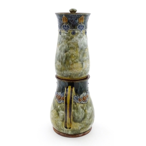 106 - A Royal Doulton stoneware water filter and jug with lid, the mottled green glaze with scrolling and ... 