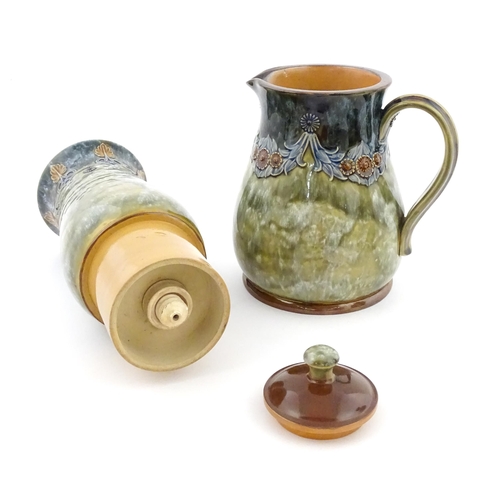 106 - A Royal Doulton stoneware water filter and jug with lid, the mottled green glaze with scrolling and ... 