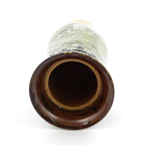 106 - A Royal Doulton stoneware water filter and jug with lid, the mottled green glaze with scrolling and ... 