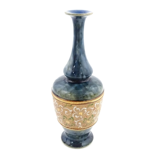 107 - A Royal Doulton bottle vase the mottled blue glaze with banded floral and foliate decoration. Marked... 