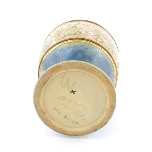 107 - A Royal Doulton bottle vase the mottled blue glaze with banded floral and foliate decoration. Marked... 