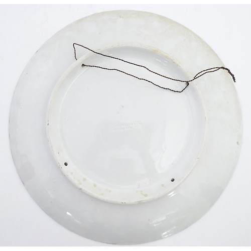 74 - A Brown Westhead / Moore & Co hand painted charger depicting a portrait. Impressed marks under. Appr... 