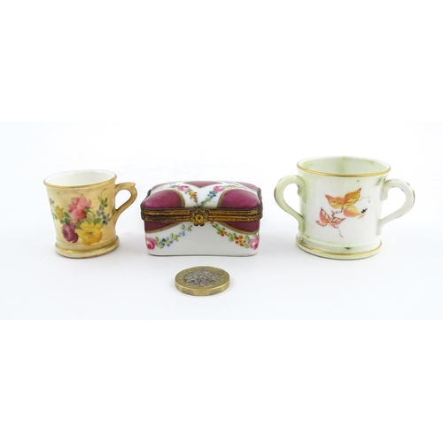 115 - Two miniature Royal Worcester items comprising a mug with floral and foliate decoration, and a tyg w... 
