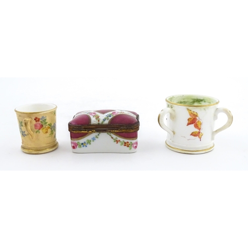 115 - Two miniature Royal Worcester items comprising a mug with floral and foliate decoration, and a tyg w... 