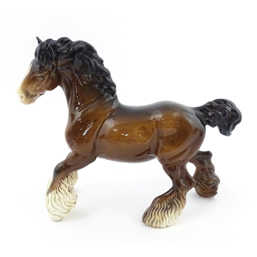 119 - A Beswick model of a Cantering Shire Horse. Marked under. Approx. 8