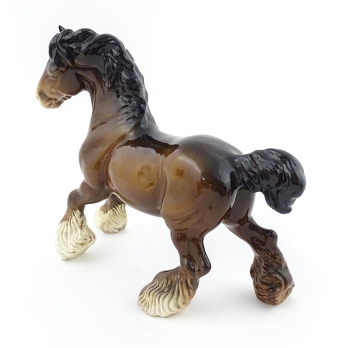 119 - A Beswick model of a Cantering Shire Horse. Marked under. Approx. 8