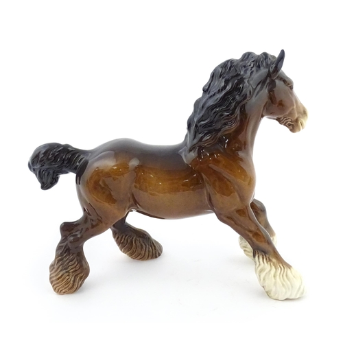 119 - A Beswick model of a Cantering Shire Horse. Marked under. Approx. 8