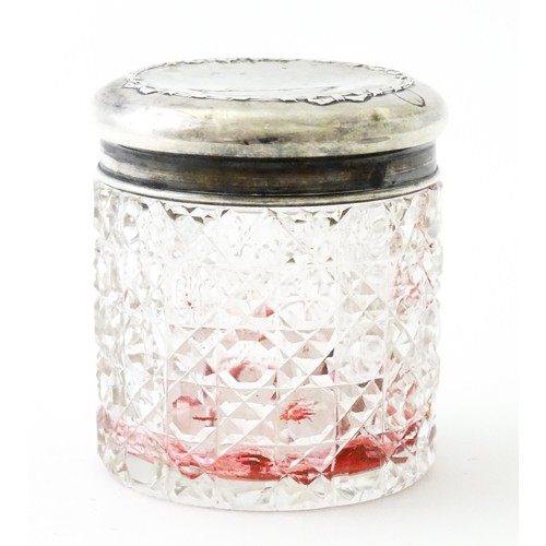 381 - A pair of cut glass dressing table pots with silver lids. Together with another. (3)