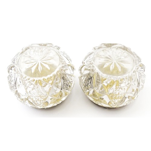 381 - A pair of cut glass dressing table pots with silver lids. Together with another. (3)