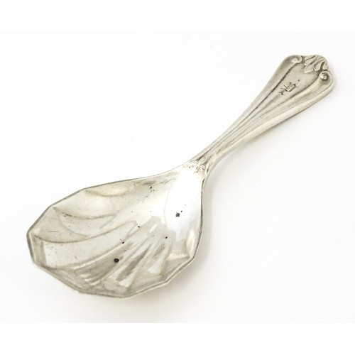 401 - A silver caddy spoon with shell formed bowl, hallmarked Birmingham 1913, maker Elkington & Co Ltd. A... 