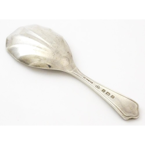 401 - A silver caddy spoon with shell formed bowl, hallmarked Birmingham 1913, maker Elkington & Co Ltd. A... 