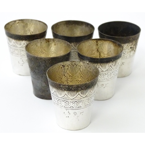 277 - A set of six white metal tot cups with engraved decoration and Persian style script. Approx 1 1/2
