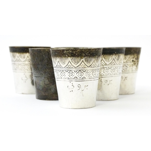 277 - A set of six white metal tot cups with engraved decoration and Persian style script. Approx 1 1/2