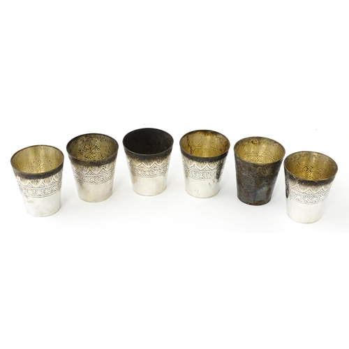277 - A set of six white metal tot cups with engraved decoration and Persian style script. Approx 1 1/2